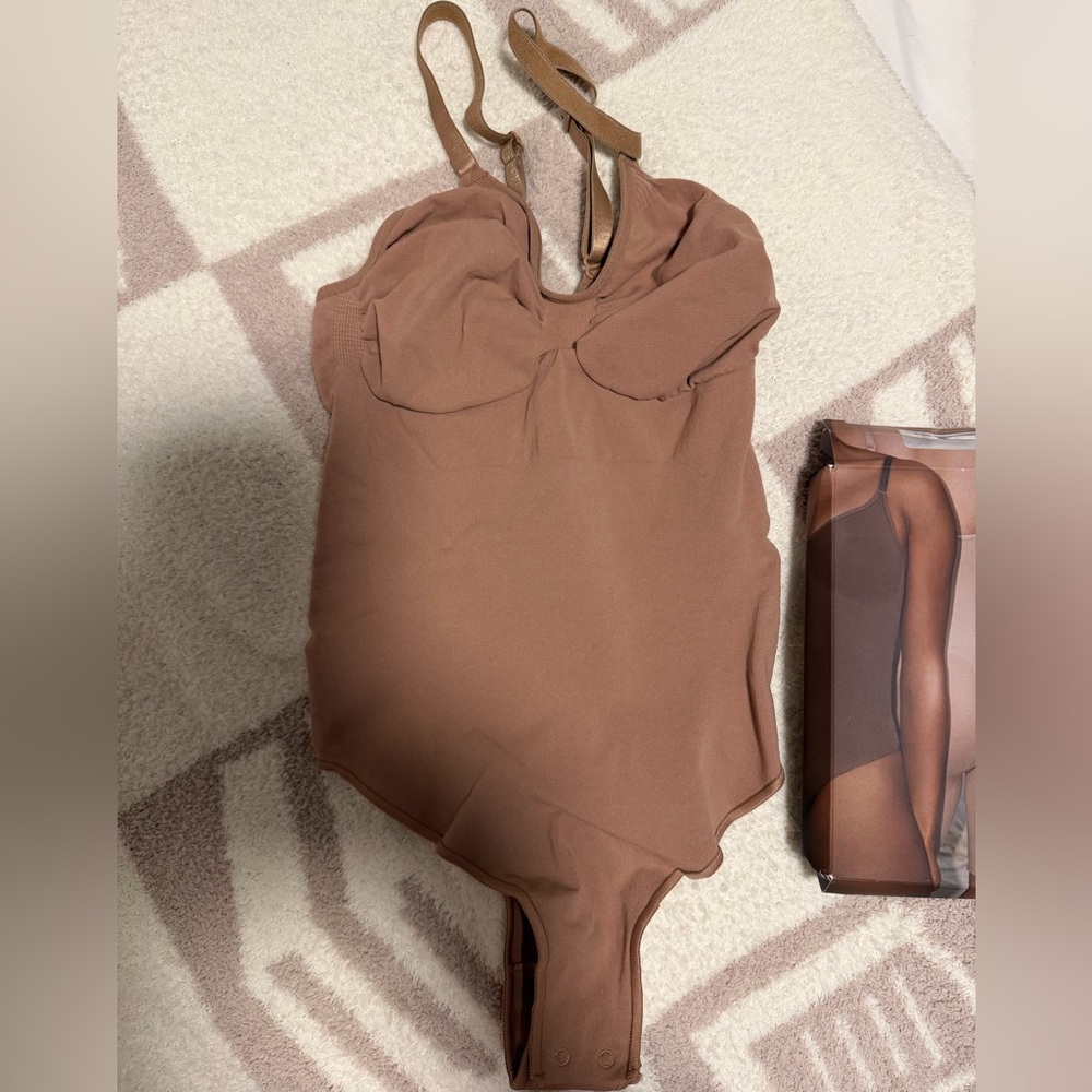SKIMS Seamless Sculpt Thong Bodysuit in the color Sienna